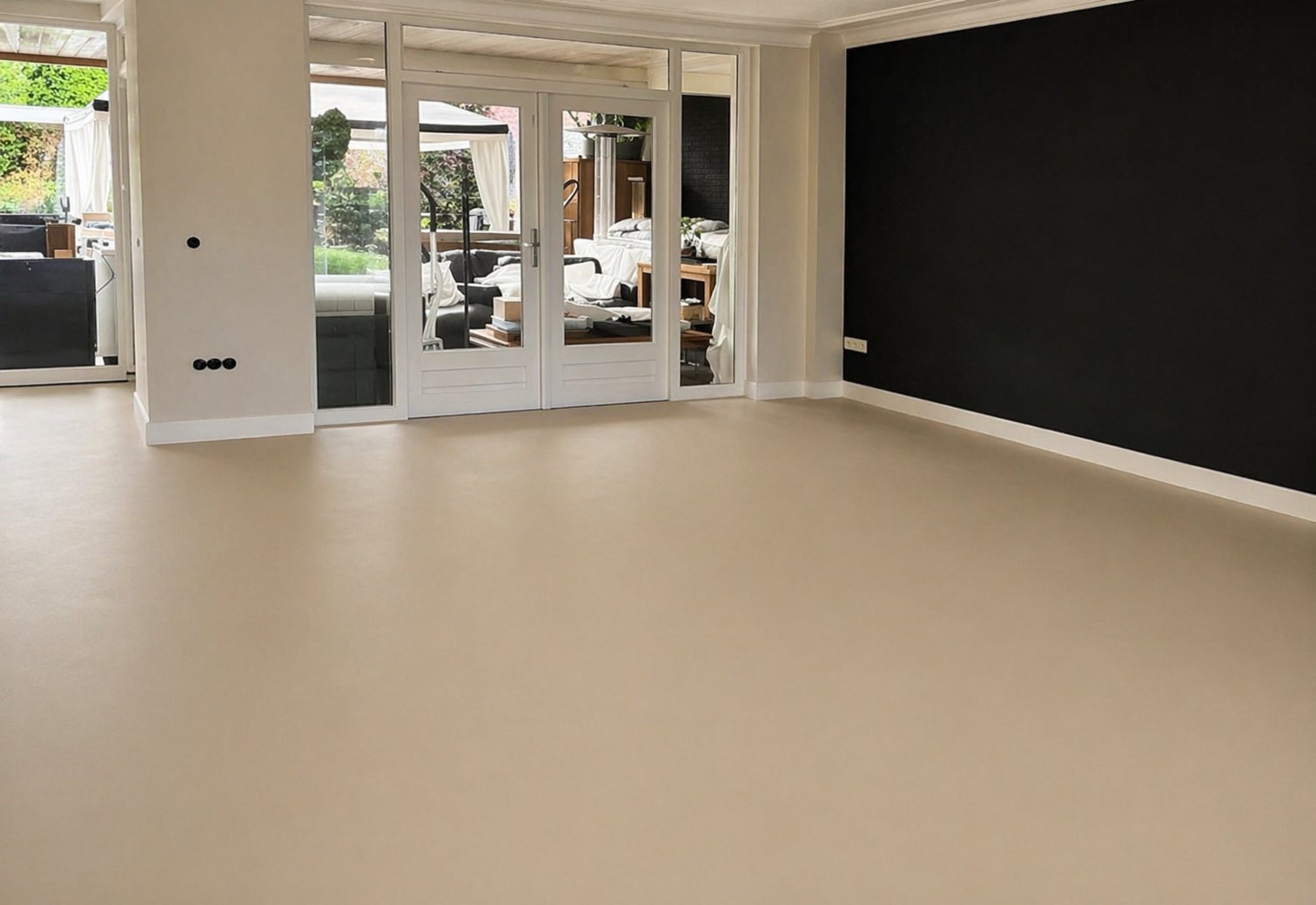 PU gietvloer beige in woonkamer met zwarte accentwand - JB Totaalvloeren